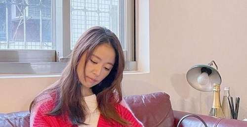 林心如躺在沙发上看书，穿红色连衫毛衣裙，慵懒造型气质佳